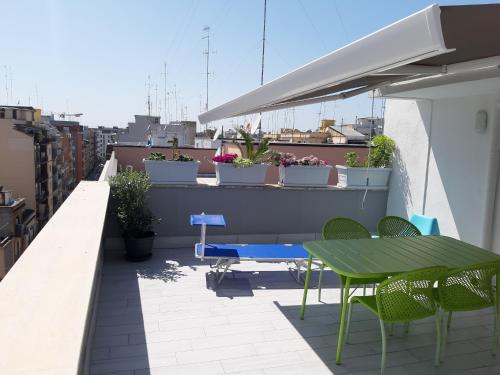 patio con tavolo e sedie sul tetto di Attico Con Terrazza A Bari a Bari