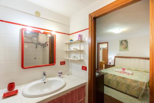 a bathroom with a sink and a mirror at Il tramonto visto da casa in Calasetta