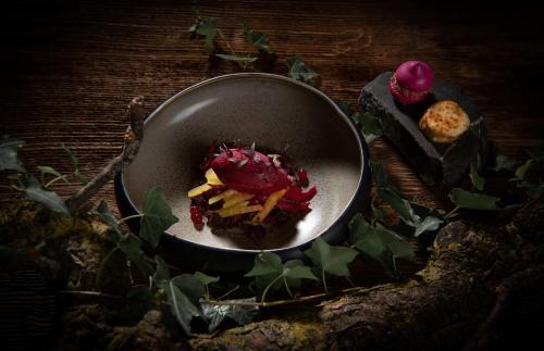 a plate of food in a bowl on a table at SALZANO Hotel - Spa - Restaurant in Interlaken