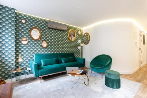 a living room with a green couch and two chairs at Embaixador Apartments&Suites in Lisbon