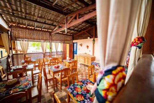 a room with wooden tables and chairs and a room with at Pousada do Ipê in São Lourenço