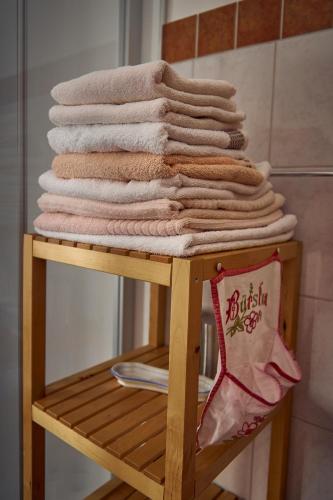 a pile of towels on a rack in a bathroom at Ferienhaus Pucher in Grundlsee