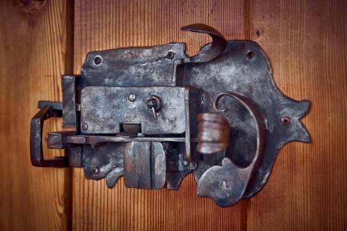 a metal object hanging on a wooden wall at Ferienhaus Pucher in Grundlsee