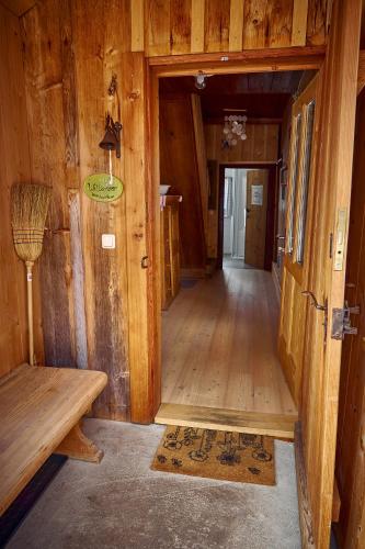 a hallway of a wooden cabin with a door and a bench at Ferienhaus Pucher in Grundlsee