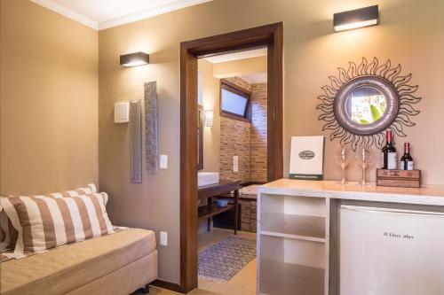 a living room with a counter and a mirror at Pousada Maya in Alto Paraíso de Goiás