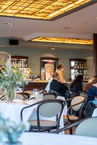 a group of people sitting at tables in a restaurant at Landgasthof Halbinsel Au in Wädenswil