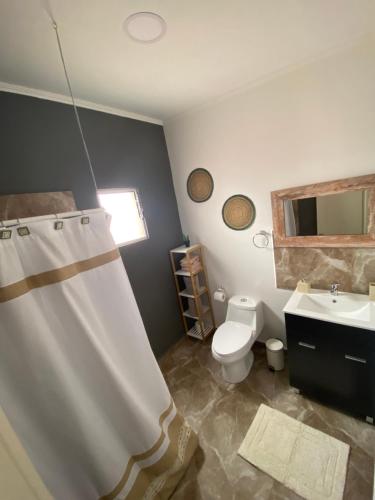 a bathroom with a toilet and a sink at Casa Campanario - San Pedro de Atacama, Desconéctate! in San Pedro de Atacama