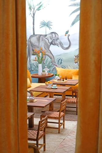 a dining room with a mural of a dinosaur at Riad Anyssates in Marrakech