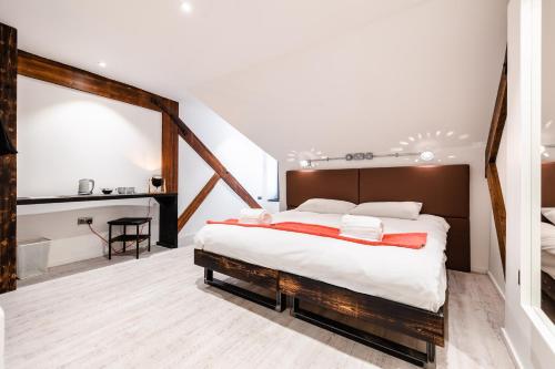a bedroom with a large bed and a bathroom at Cardiff Arms Bistro & Hotel in Treorky