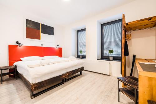 a bedroom with a large bed with a red headboard at Cardiff Arms Bistro & Hotel in Treorky
