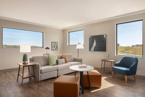 a living room with a couch and a chair at Staybridge Suites Rochester - Mayo Clinic Area by IHG in Rochester