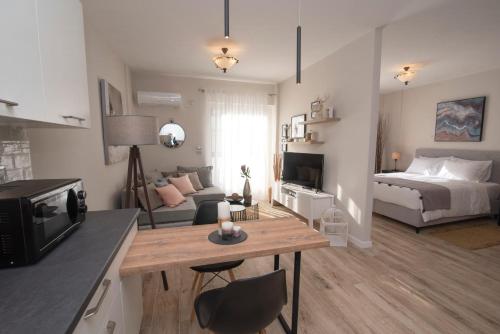 a living room with a bed and a table in a room at Chrysalis 1 in Kos