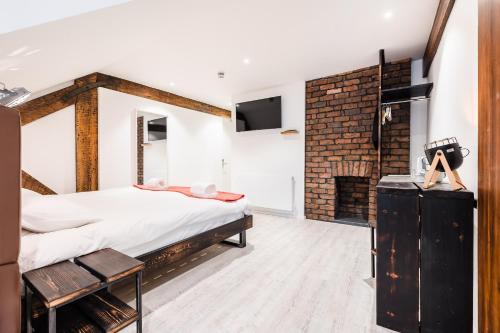 a bedroom with a bed and a fireplace at Cardiff Arms Bistro & Hotel in Treorky