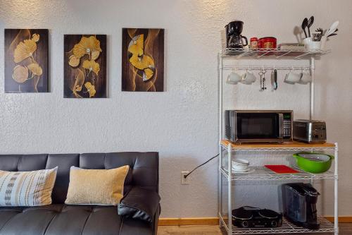 a living room with a couch and some paintings at Couples Getaway - Sweet Retreat - European Village Best Location in Palm Coast