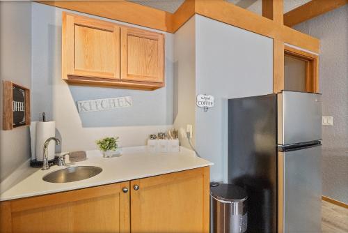 a kitchen with a sink and a refrigerator at Couples Getaway - Sweet Retreat - European Village Best Location in Palm Coast