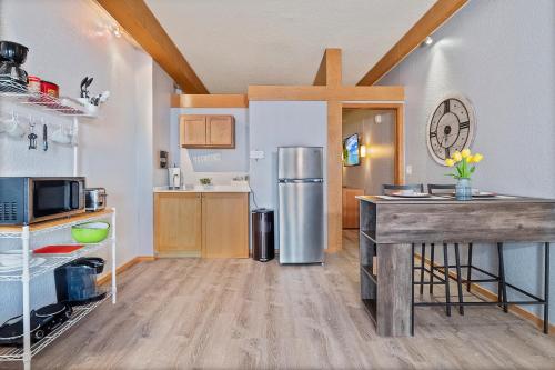 a kitchen with a refrigerator and a table in it at Couples Getaway - Sweet Retreat - European Village Best Location in Palm Coast