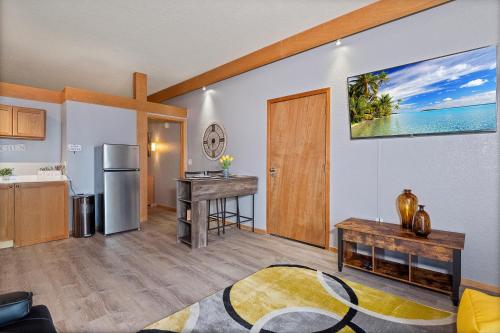 a kitchen and living room with a refrigerator and a table at Couples Getaway - Sweet Retreat - European Village Best Location in Palm Coast