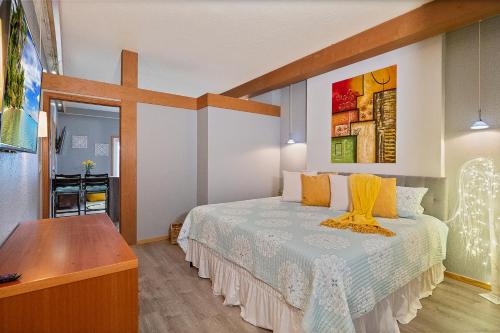 a bedroom with a bed with a cross on the wall at Couples Getaway - Sweet Retreat - European Village Best Location in Palm Coast