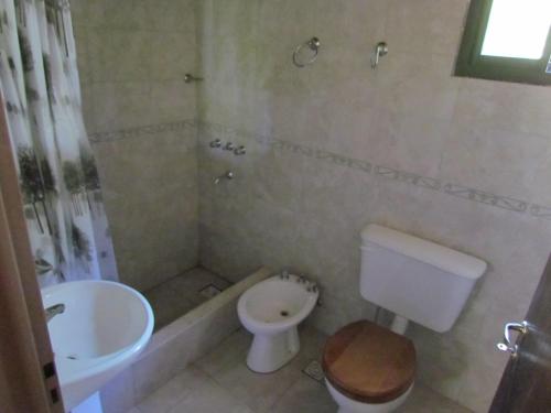 a bathroom with a sink and a toilet and a tub at Cabañas de Montaña San Miguel in Cortaderas