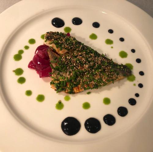 a white plate with a piece of food on it at Luna Wellness Hotel in Folgarida