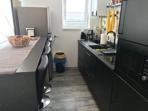 a kitchen with black cabinets and a counter top at Fok Flat Sibiu in Turnişor