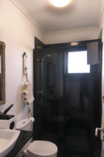 a bathroom with a toilet and a sink and a shower at Casa Azul - Ocean View in Porto Moniz