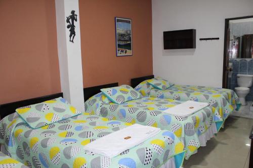 Postel nebo postele na pokoji v ubytování Hostal Isla Señorial
