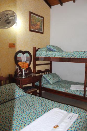 Postel nebo postele na pokoji v ubytování Hostal Isla Señorial