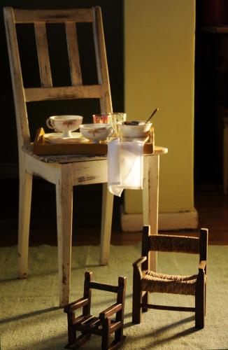 a table and a chair in a room with a table and a table at Los Juncos Patagonian Lake House in San Carlos de Bariloche