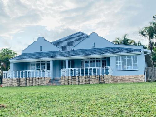a blue house with a fence in front of it at Beautiful Villa - Scottburgh, Durban in Scottburgh