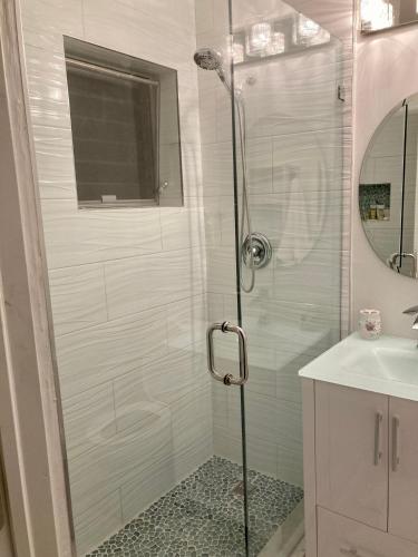 a shower with a glass door in a bathroom at Gorgeous Beachy Chic Condo in Key Biscayne in Miami
