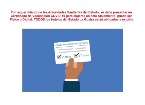 a hand holding a piece of paper with a check at Hotel Villa Playa Grande in Playa Grande