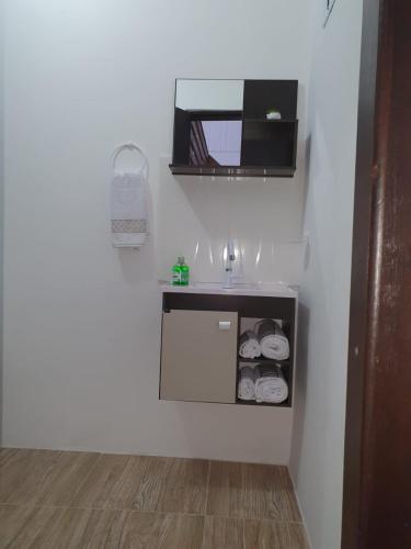 a bathroom with a sink and a mirror on the wall at Pousada Korb in Santo Amaro da Imperatriz