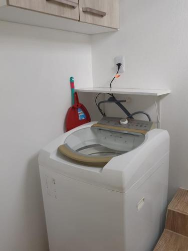 a washing machine with a cord on top of it at Pousada Korb in Santo Amaro da Imperatriz