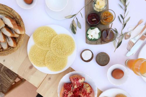 a table with two plates of food and bread at Riad Azzouna 13 in Marrakech
