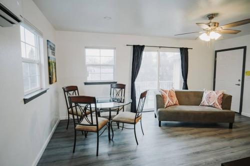 a living room with a couch and a table and chairs at Gorgeous Upstairs Studio with Patio and Laundry in Chico