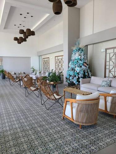 a living room with a christmas tree and a couch and chairs at Fantastic Beach condo with pool and mountain views in Nueva Gorgona