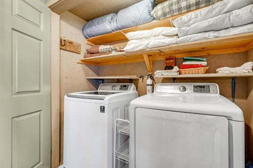 a laundry room with a washer and dryer at The BearFoote Chalet in Seven Devils