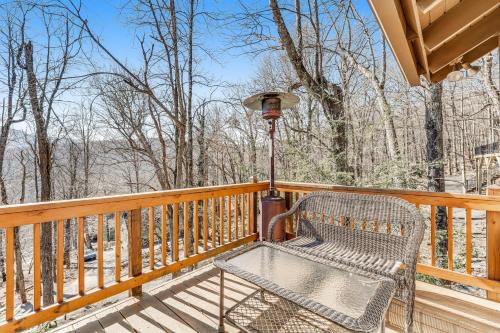 a bench sitting on a wooden deck with a light at The BearFoote Chalet in Seven Devils