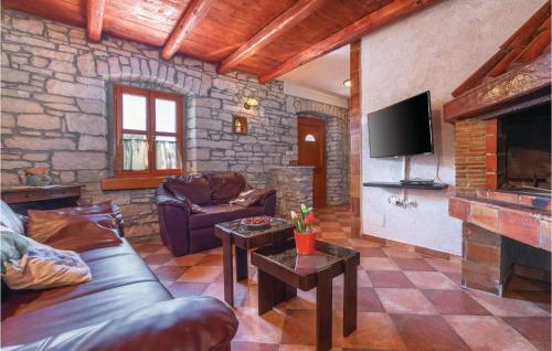 salon z kanapą i kominkiem w obiekcie Beautiful Home In Hrboki With Wifi w mieście Hrboki