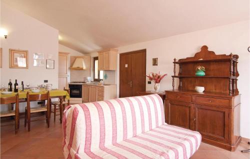 a living room with a couch and a kitchen at Casa Grande in Torricella