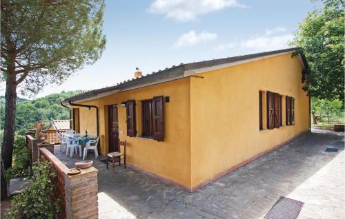 a yellow house with a table and a patio at Casa Grande in Torricella