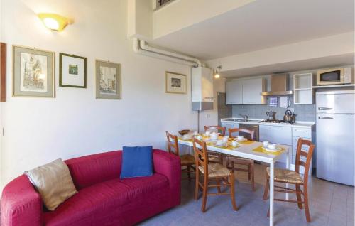 a living room with a red couch and a table with chairs at Volpe in Camaiore