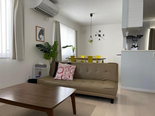 a living room with a couch and a table at Bayside in Hakodate