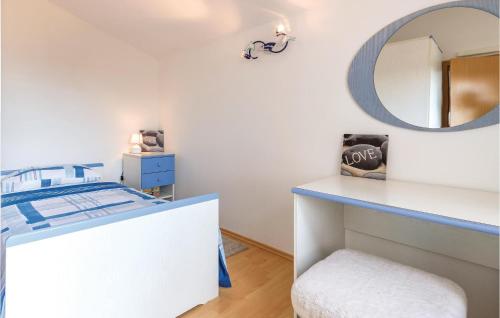 a bedroom with a mirror and a bed and a stool at Stunning Apartment In Marcana With Kitchen in Marčana