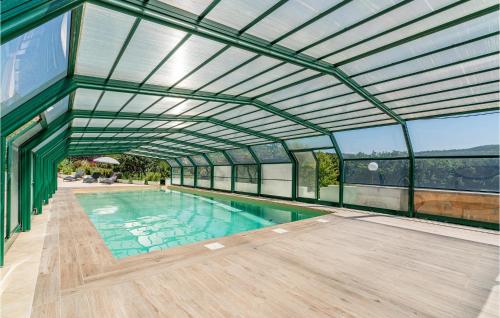 an indoor swimming pool with a metal roof at La Collina in Murlo