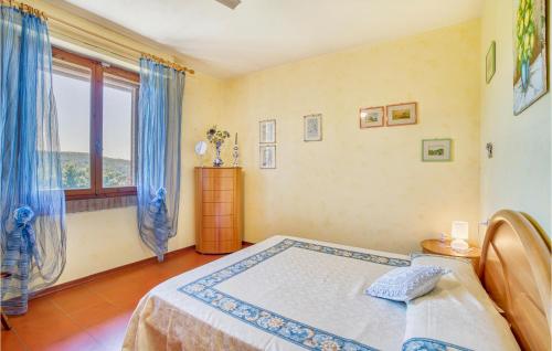 a bedroom with a bed and a large window at La Collina in Murlo