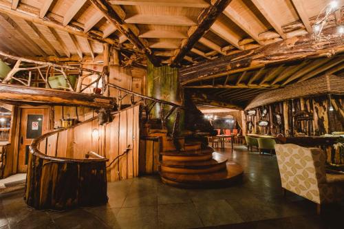 a room with wooden walls and stairs in a building at Huilo Huilo Montaña Mágica in Huilo Huilo