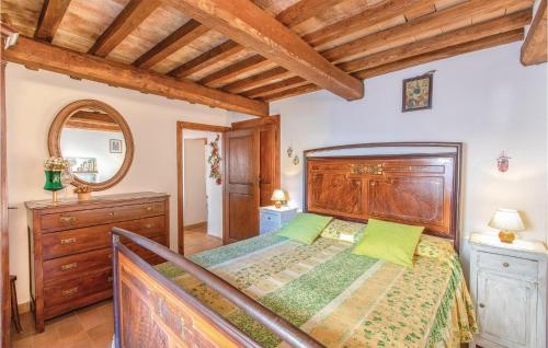 a bedroom with a wooden bed and a wooden dresser at Longino in Baschi