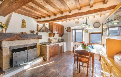 a kitchen with a table and a stove top oven at Longino in Baschi